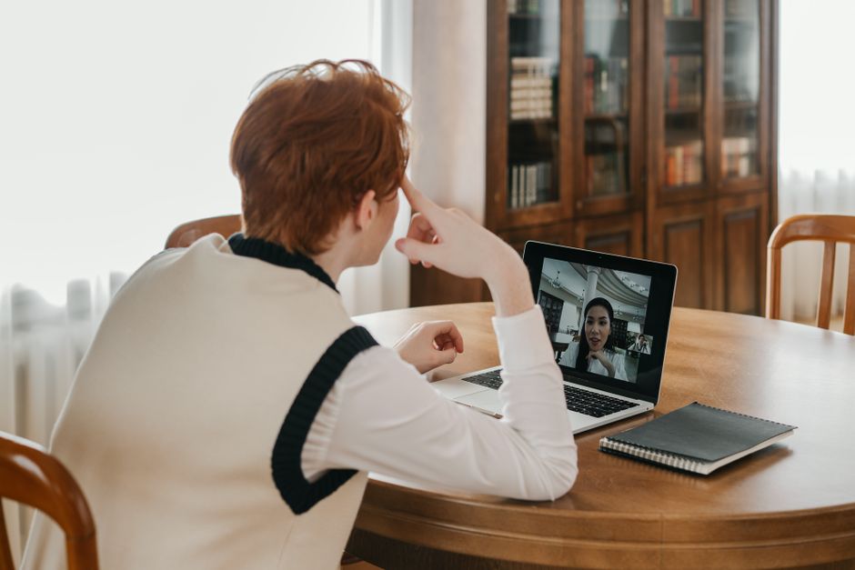 A man on a video call at a table