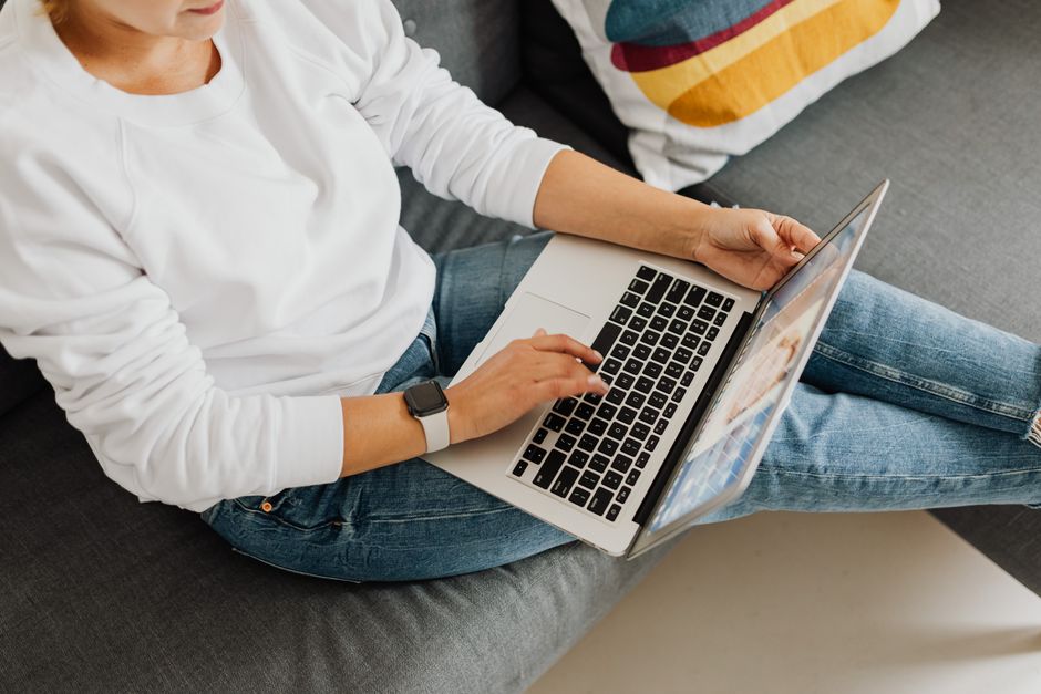 A person working on a laptop at home