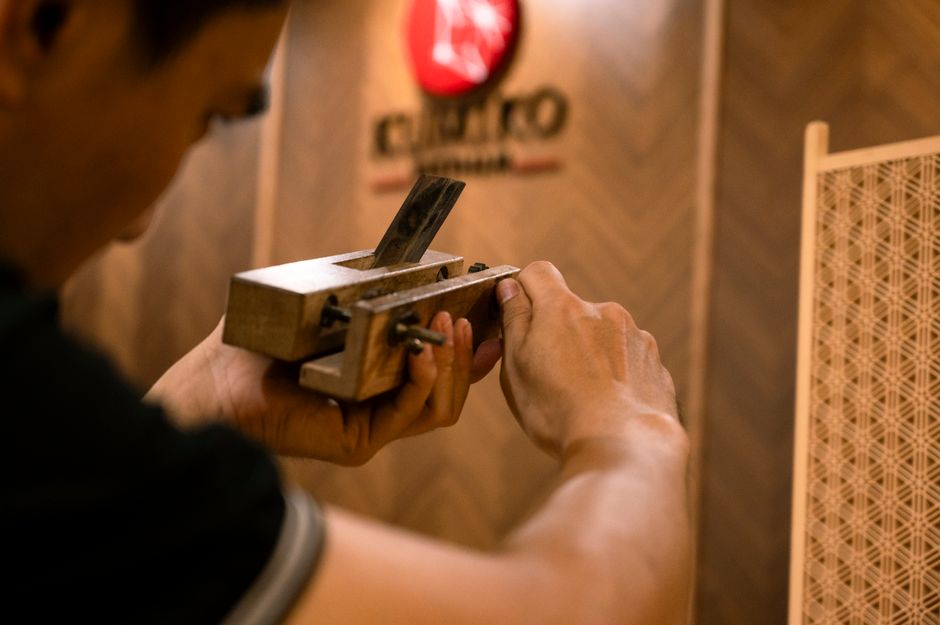 A craftsman using a Japanese hand plane
