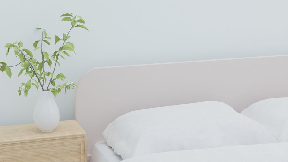 A styled bedroom with white bedding
